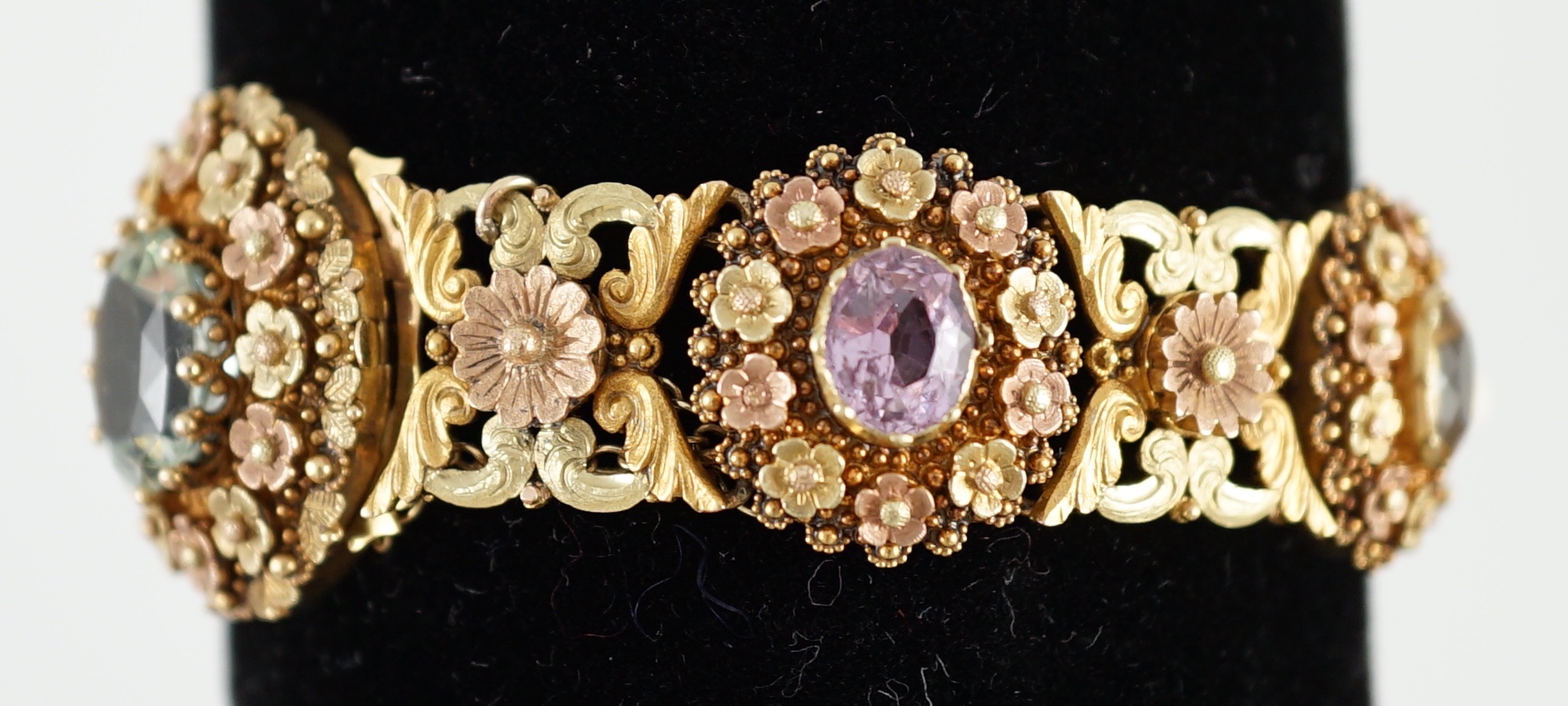 A 19th century pierced three colour gold, pink topaz, moonstone, citrine and aquamarine set bracelet.
